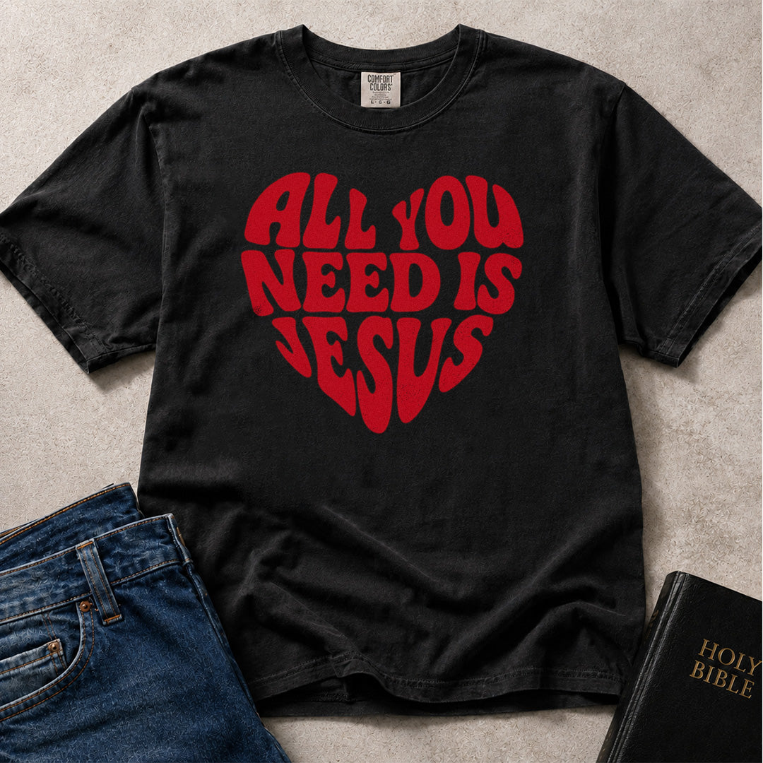 Black (Black) Comfort Colors® 1717 tee with All You Need Is Jesus text in a heart shaped layout.