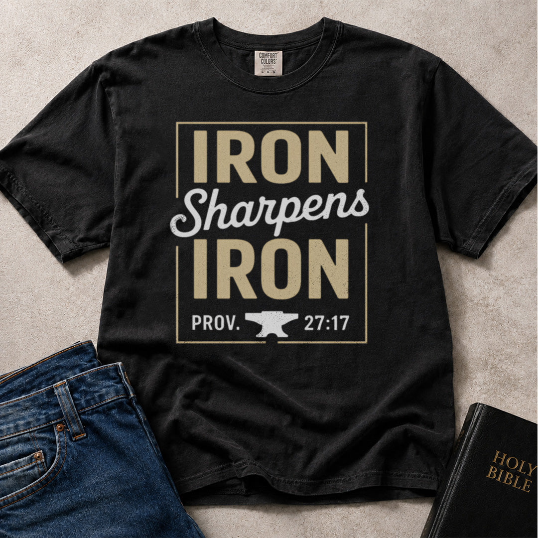 Black Comfort Colors® 1717 tee with Iron Sharpens Iron text and Proverbs 27:17 scripture reference.
