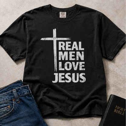 Real Men Love Jesus Christian lifestyle graphic on black Comfort Colors 1717® tee.