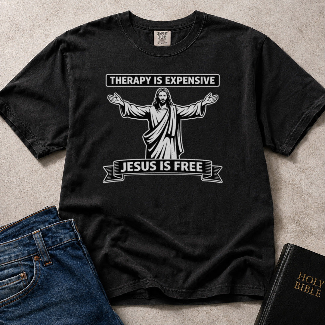 Therapy is Expensive, Jesus is Free funny Christian message print on black Comfort Colors 1717® shirt.