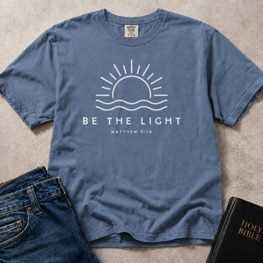 Blue (Blue Jean) Comfort Colors® 1717 Bible inspired tshirt showcasing encouraging Be the Light graphic design from Matthew 5:14.