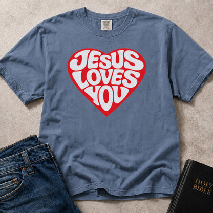 Blue (Blue Jean) Comfort Colors® 1717 t-shirt with a bold heart graphic and "Jesus Loves You" lettering in a groovy retro style.