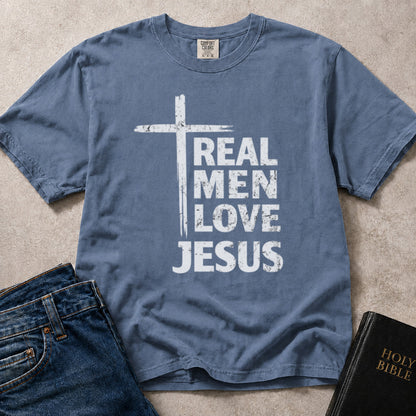 Real Men Love Jesus Christian statement graphic on blue (Blue Jean) Comfort Colors 1717® shirt.
