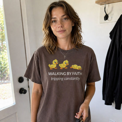 Woman in entryway wearing Walking by Faith Tripping Constantly funny faith based graphic on a brown (Espresso) Comfort Colors 1717® t-shirt.