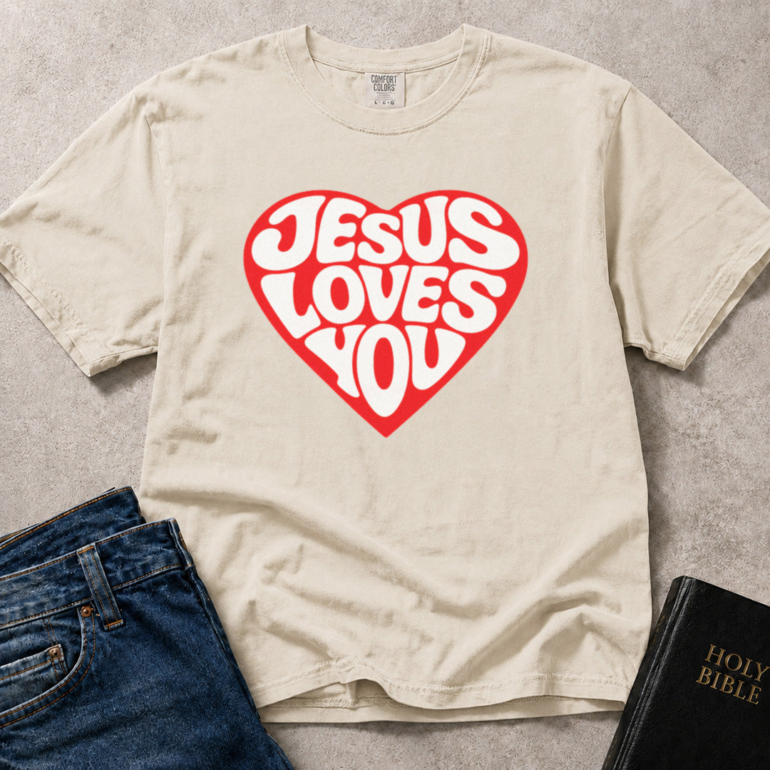 Off White (Ivory) Comfort Colors® 1717 tshirt with a bold heart graphic and "Jesus Loves You" in vintage style lettering, a scripture based design with a clean, encouraging look.