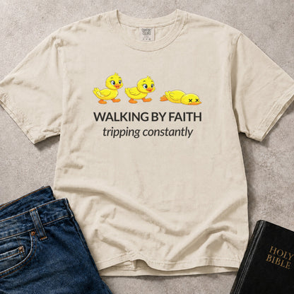 Walking by Faith Tripping Constantly funny Christian design on an off white (Ivory) Comfort Colors 1717® tee.