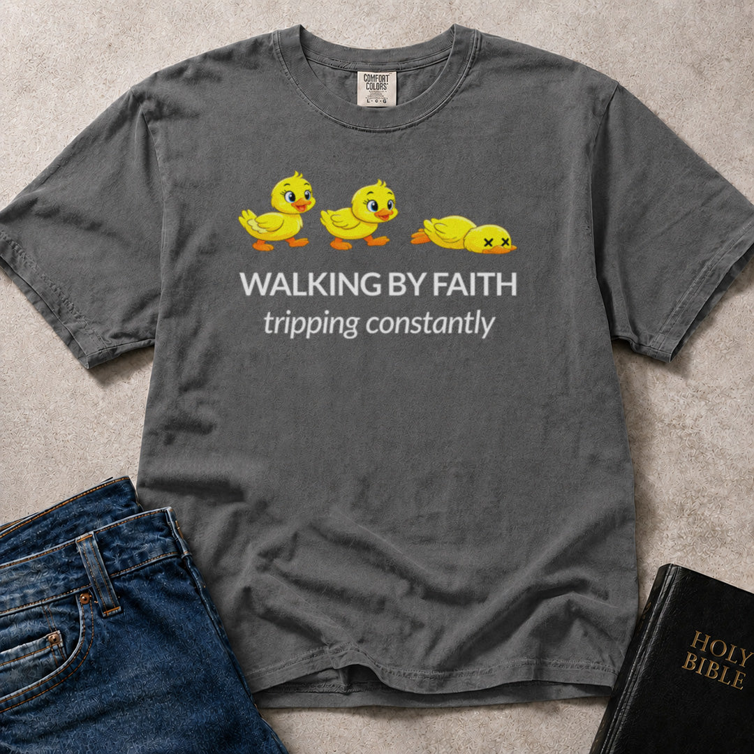 Walking by Faith Tripping Constantly funny faith based graphic on a faded black (Pepper) Comfort Colors 1717® t-shirt.